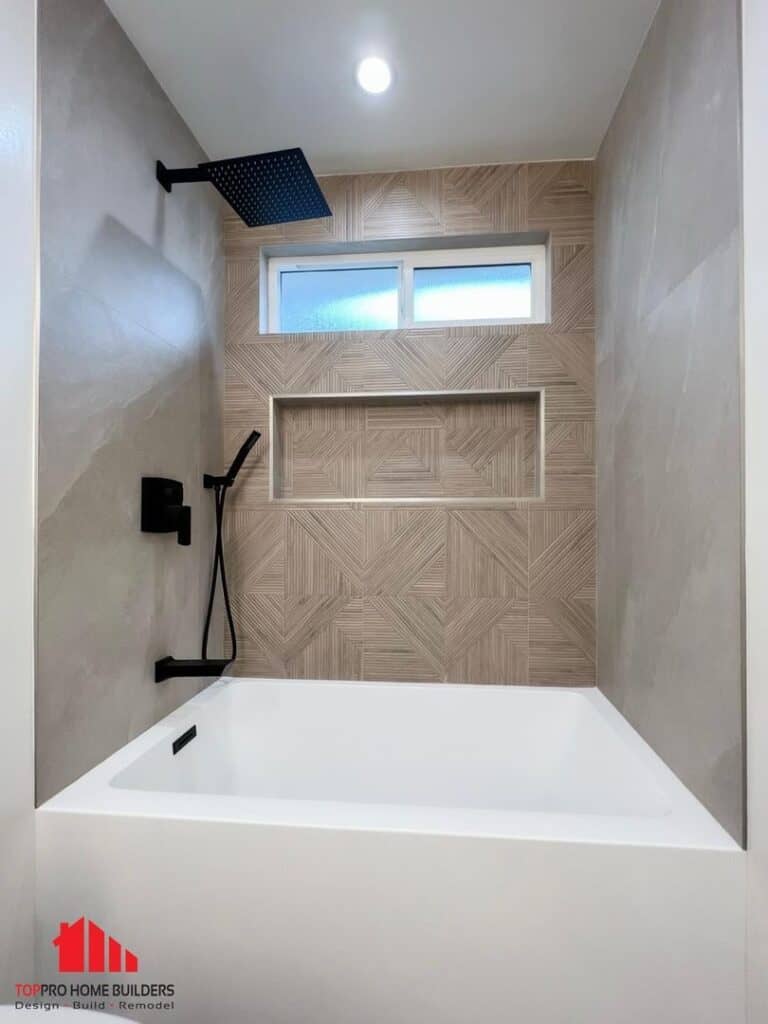 Bathroom with white tub, geometric tiles, and matte black fixtures.