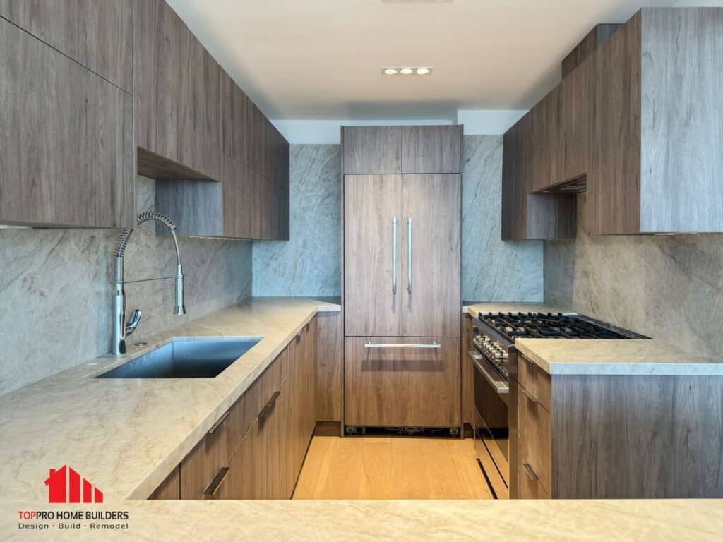 Modern kitchen with wooden cabinets, marble countertops, and stainless steel appliances.