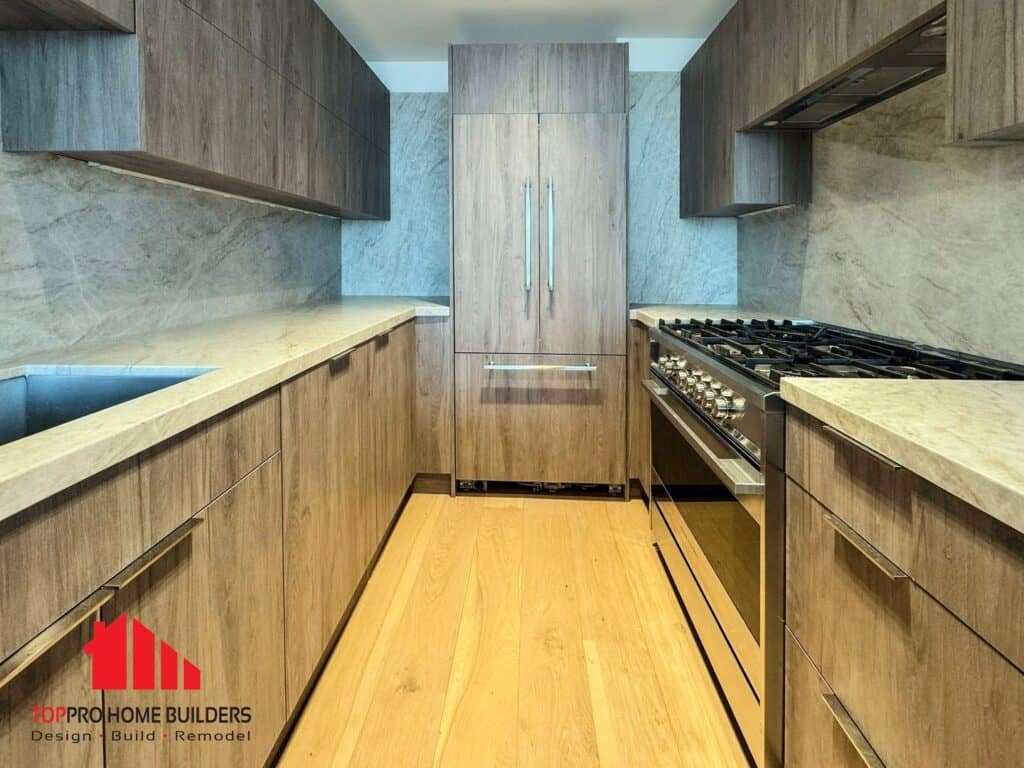 Modern kitchen with wooden cabinets, marble countertops, and stainless steel appliances.