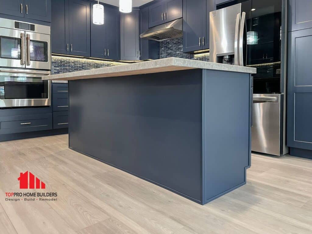 Image of a modern kitchen with blue cabinets and stainless steel appliances.